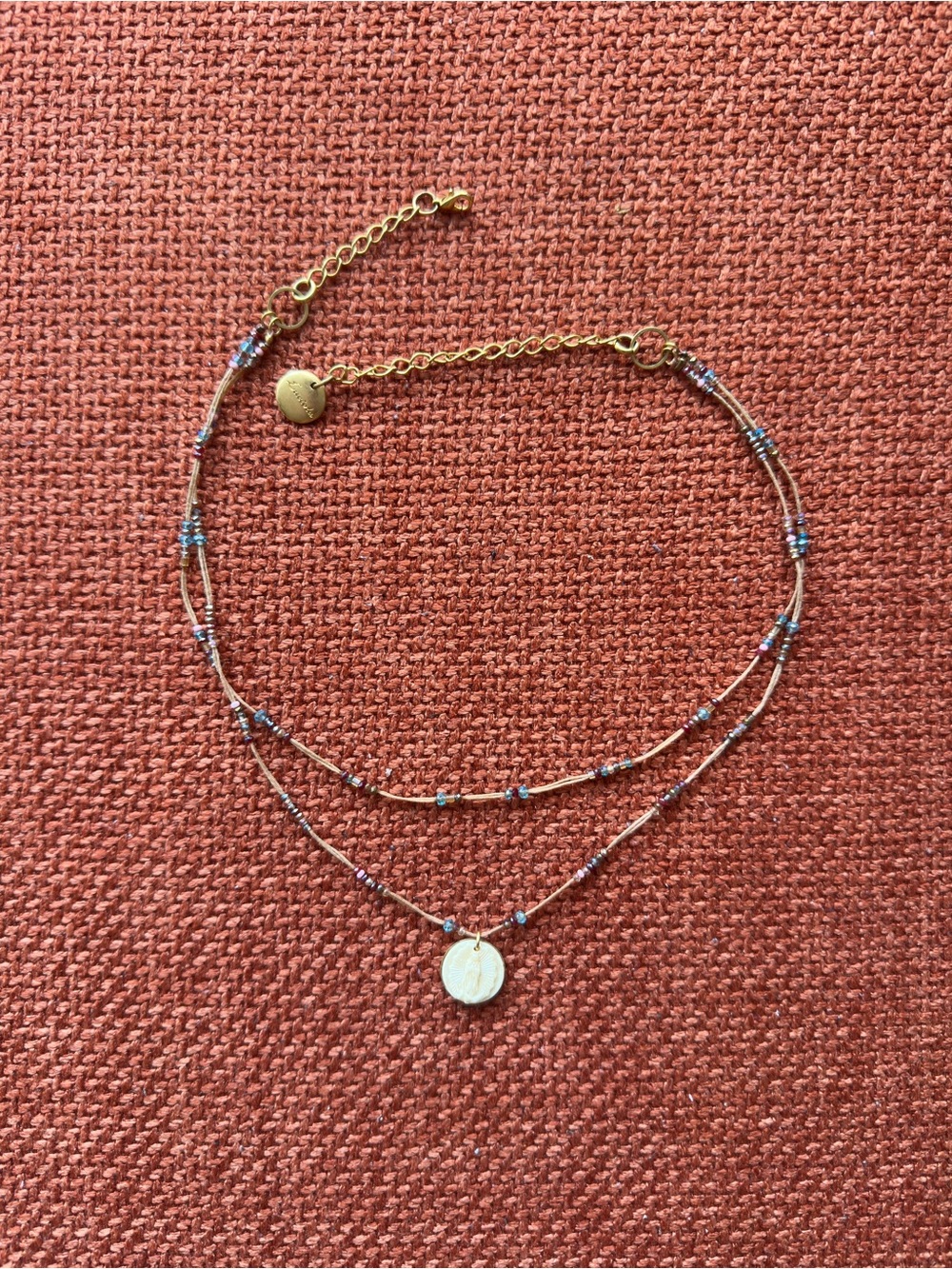 Beaded necklace with small circular
Virgen de Guadalupe pendant